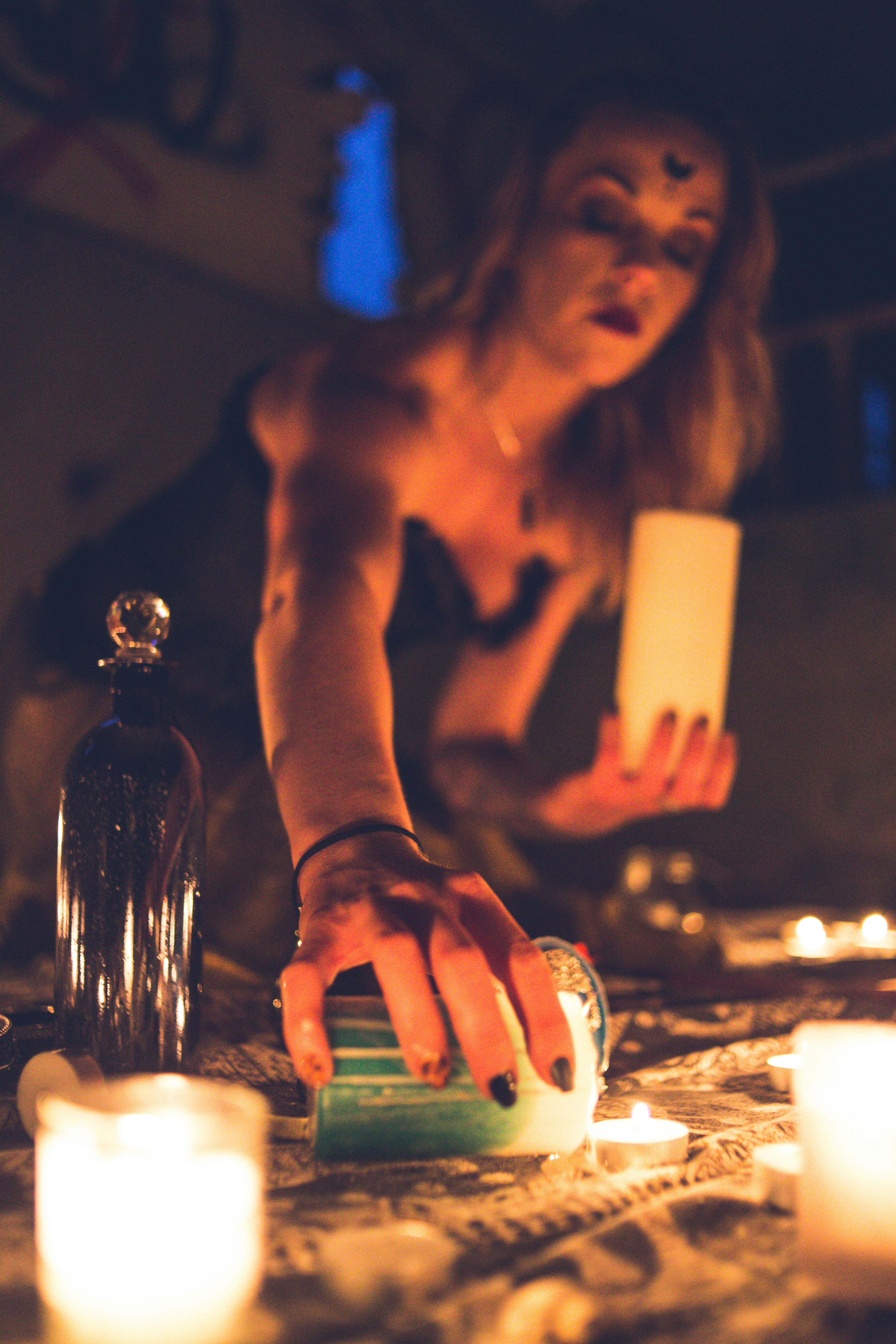 topless woman holding lighted candle