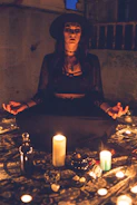 A mystical traveler woman performing a ritual with candles and crystals