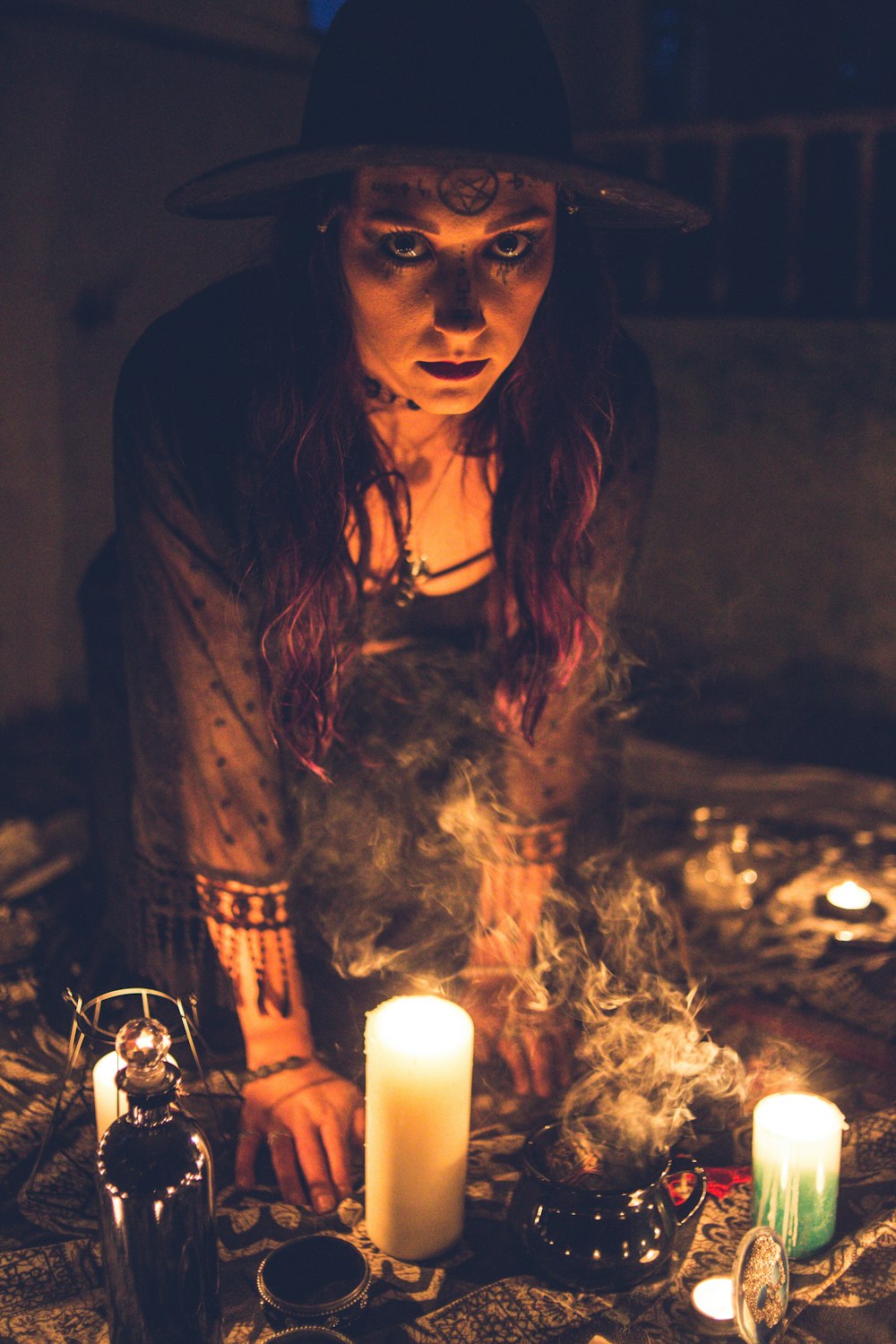 woman in brown long sleeve shirt holding white candle