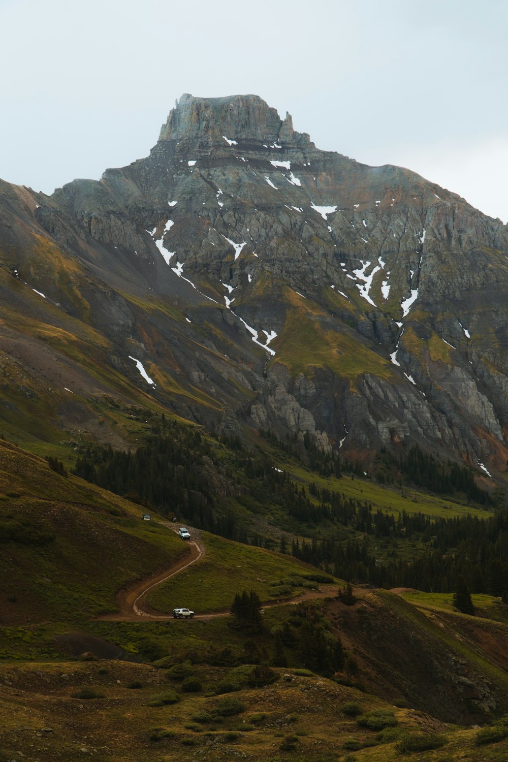 green and brown mountains under white sky during daytime