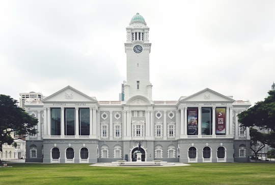 white concrete building with clock tower in Asian Civilisations Museum Singapore