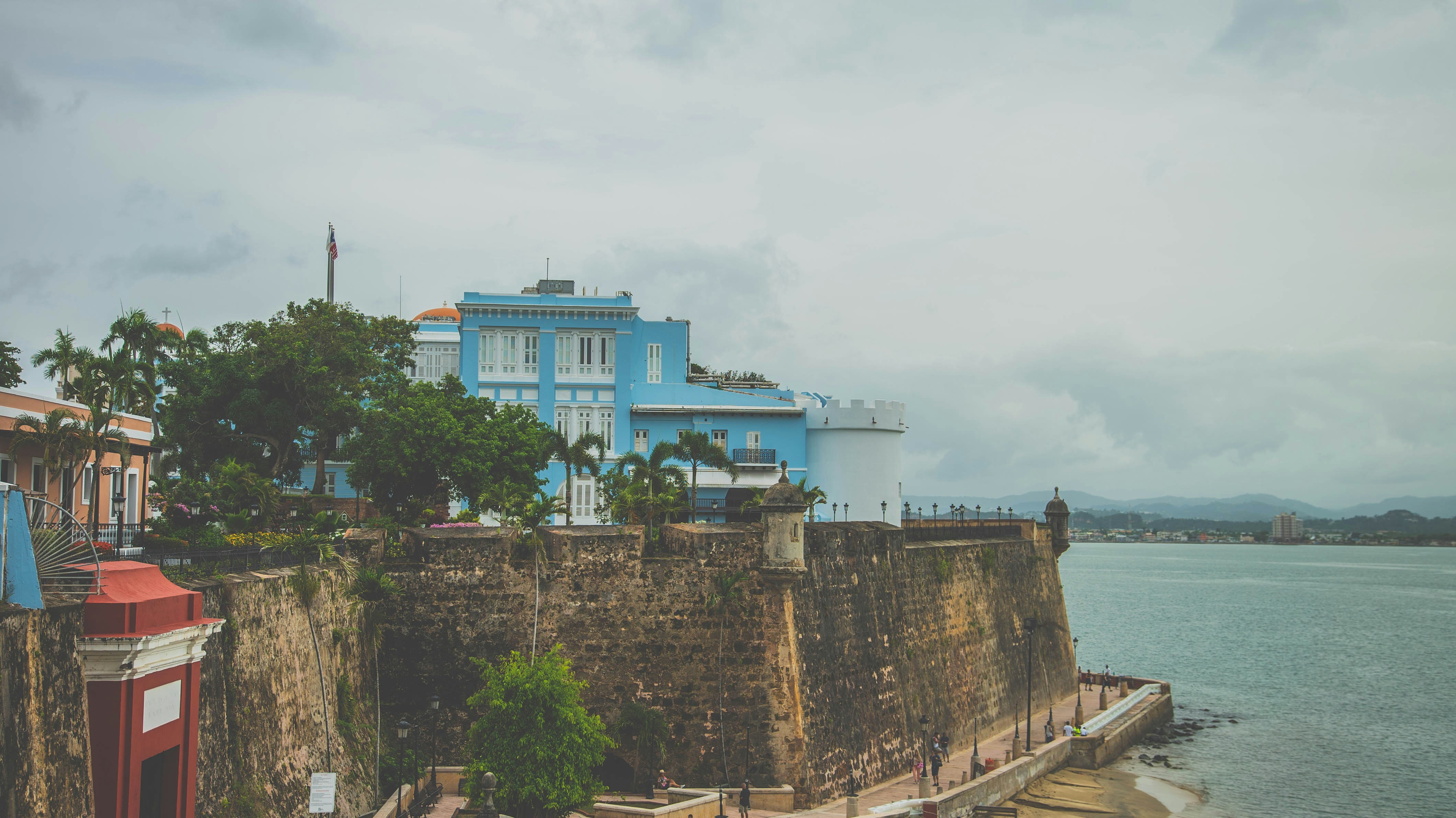 Historic hotel with stone walls and modern pool area overlooking the Caribbean Sea in Roseau