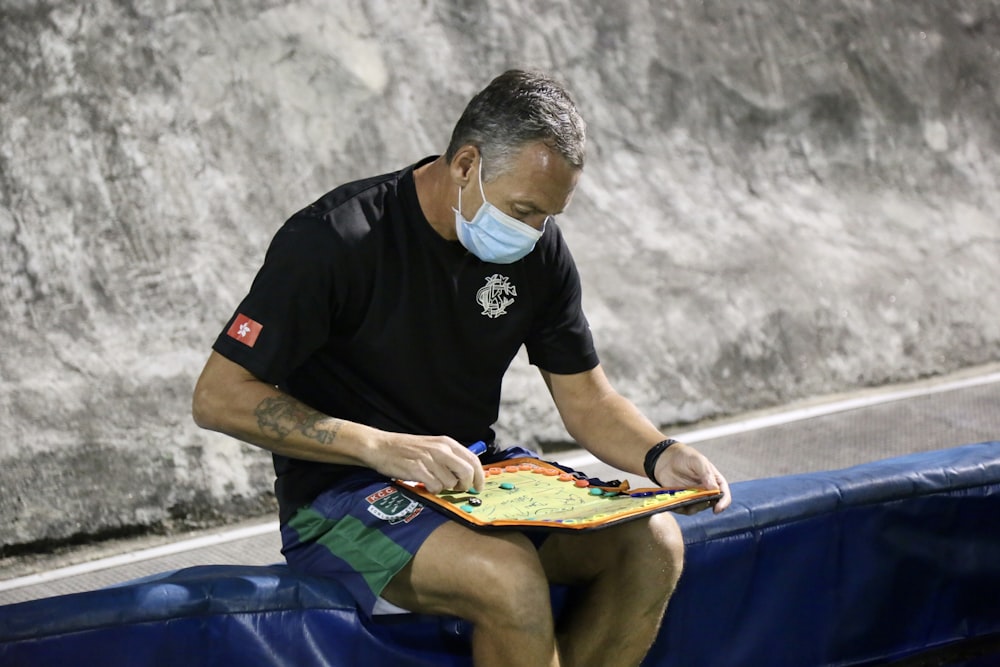 a man preparing a tactical plan for a team photo taken by a sports writer