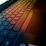 A close-up of a Clairvo laptop keyboard glowing softly in a minimalist workspace.