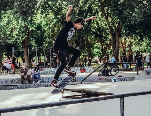 A professional competition skateboard being ridden fast down a skatepark ramp.