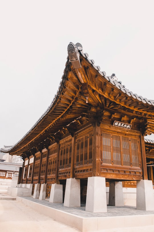 brown and white wooden temple in Namsangol Hanok Village South Korea