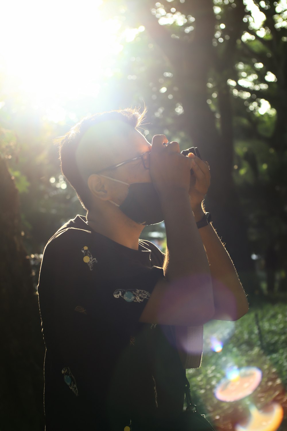 woman in black and red floral shirt wearing black sunglasses