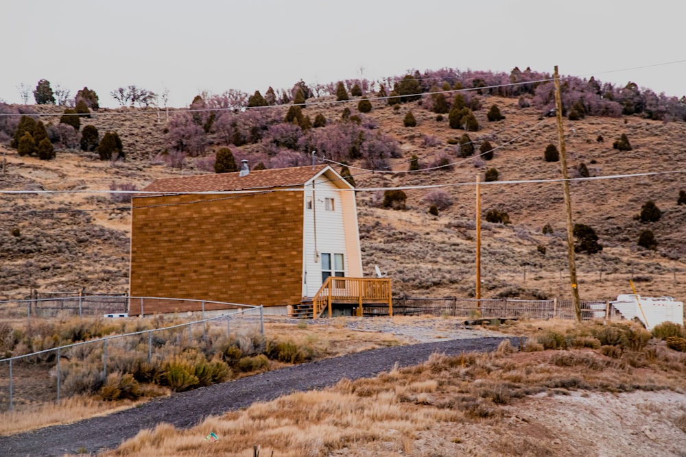 white and brown concrete house near brown mountain during daytime