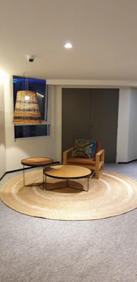 Small apartment nook styled with layered rugs and cozy seating.