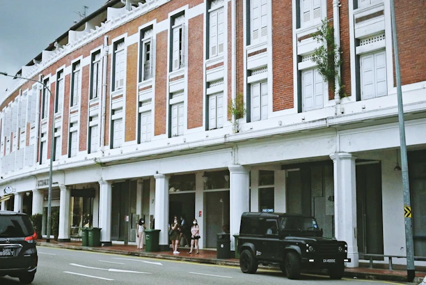 black suv parked in front of white building