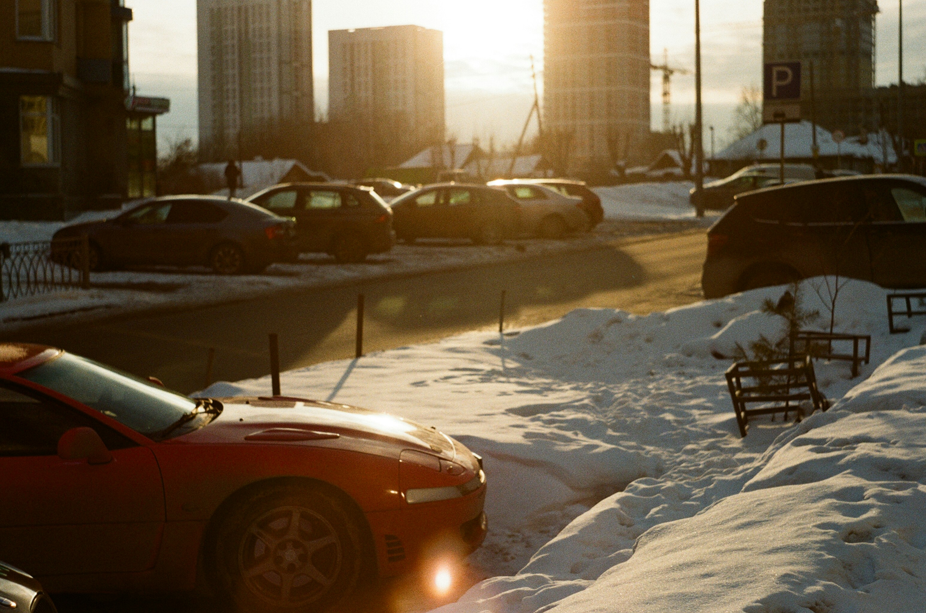 Multiple electric cars plugged into curbside chargers on a winter street in Norway
