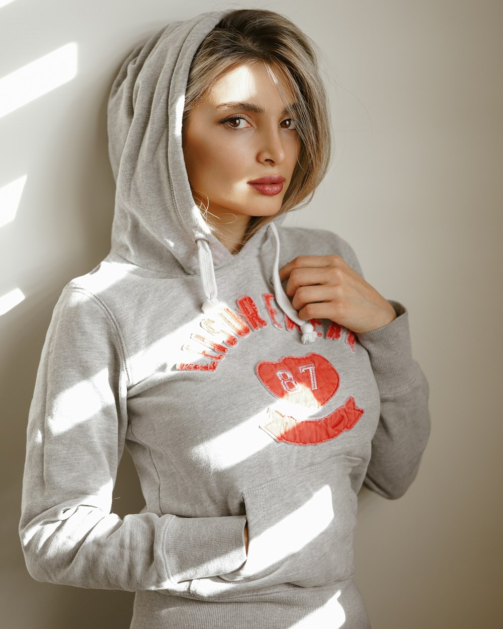 woman in gray and red pullover hoodie