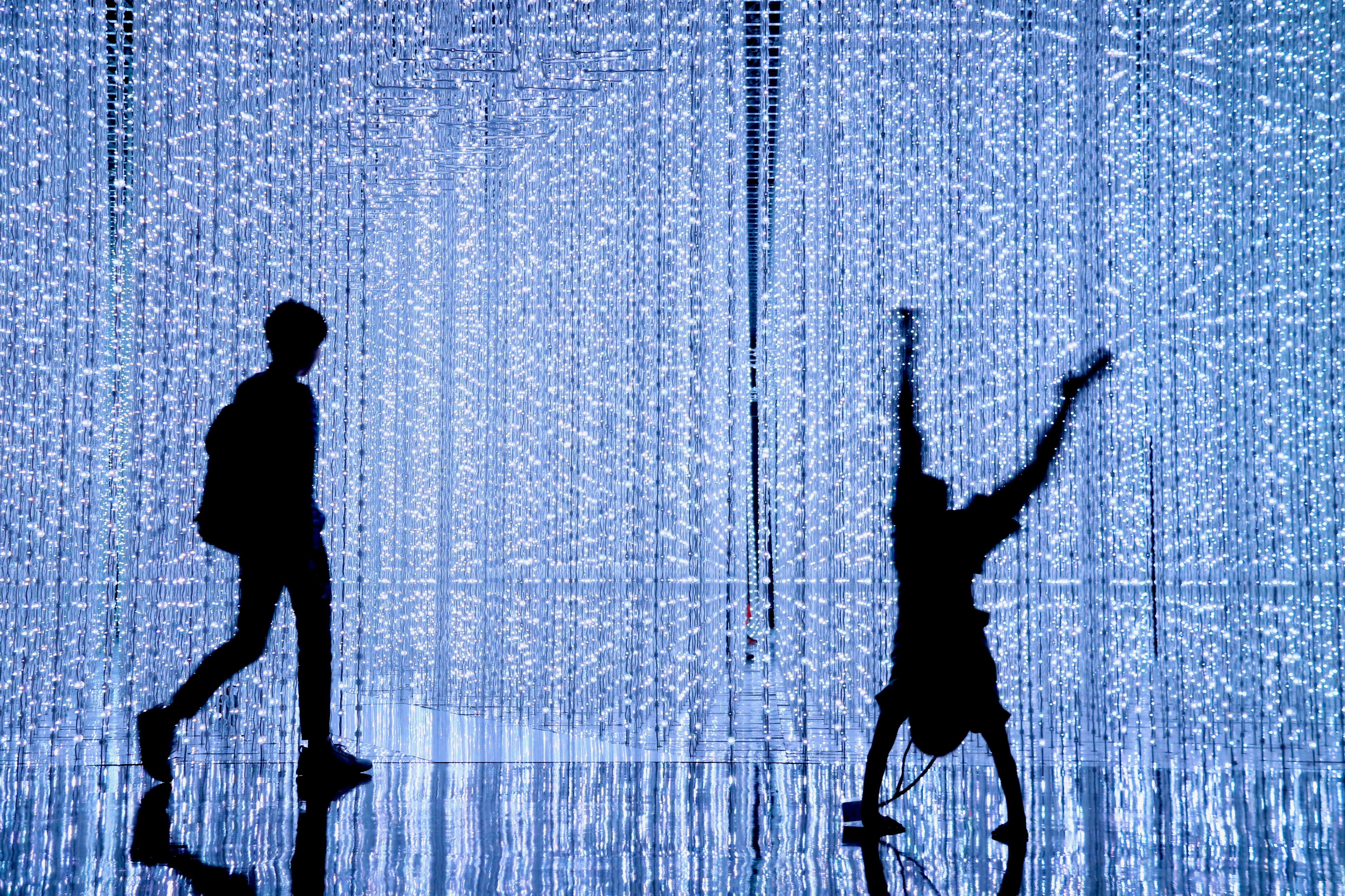 A split screen image showing two different people walking, with motion analysis lines superimposed on their legs and bodies to compare gait patterns.