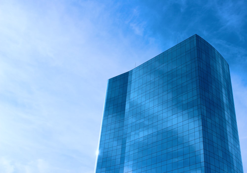 blue glass walled high rise building