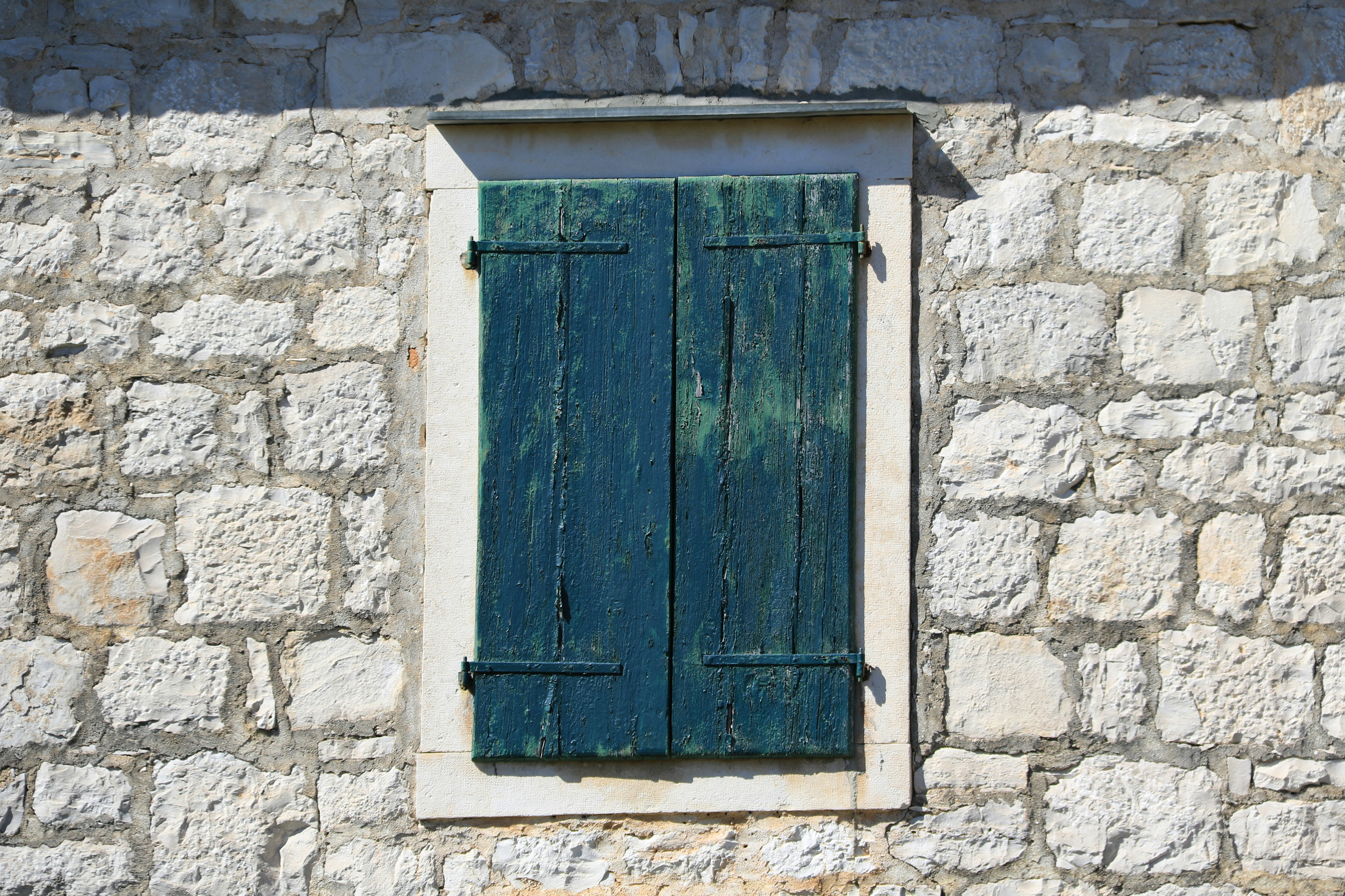 Blue wooden door on white brick wall