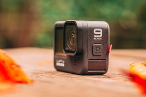 black camera on brown wooden table