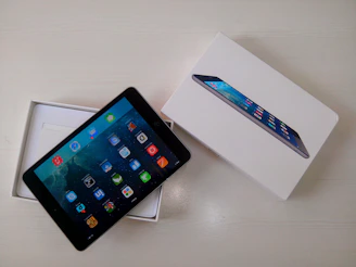 Close-up of hands unboxing a new tablet with excitement.