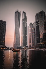 high rise building near body of water during night time