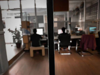 Side-by-side comparison of two columns: left dark background showing frustrated worker with piles of paperwork, right teal background with a calm professional using a laptop.