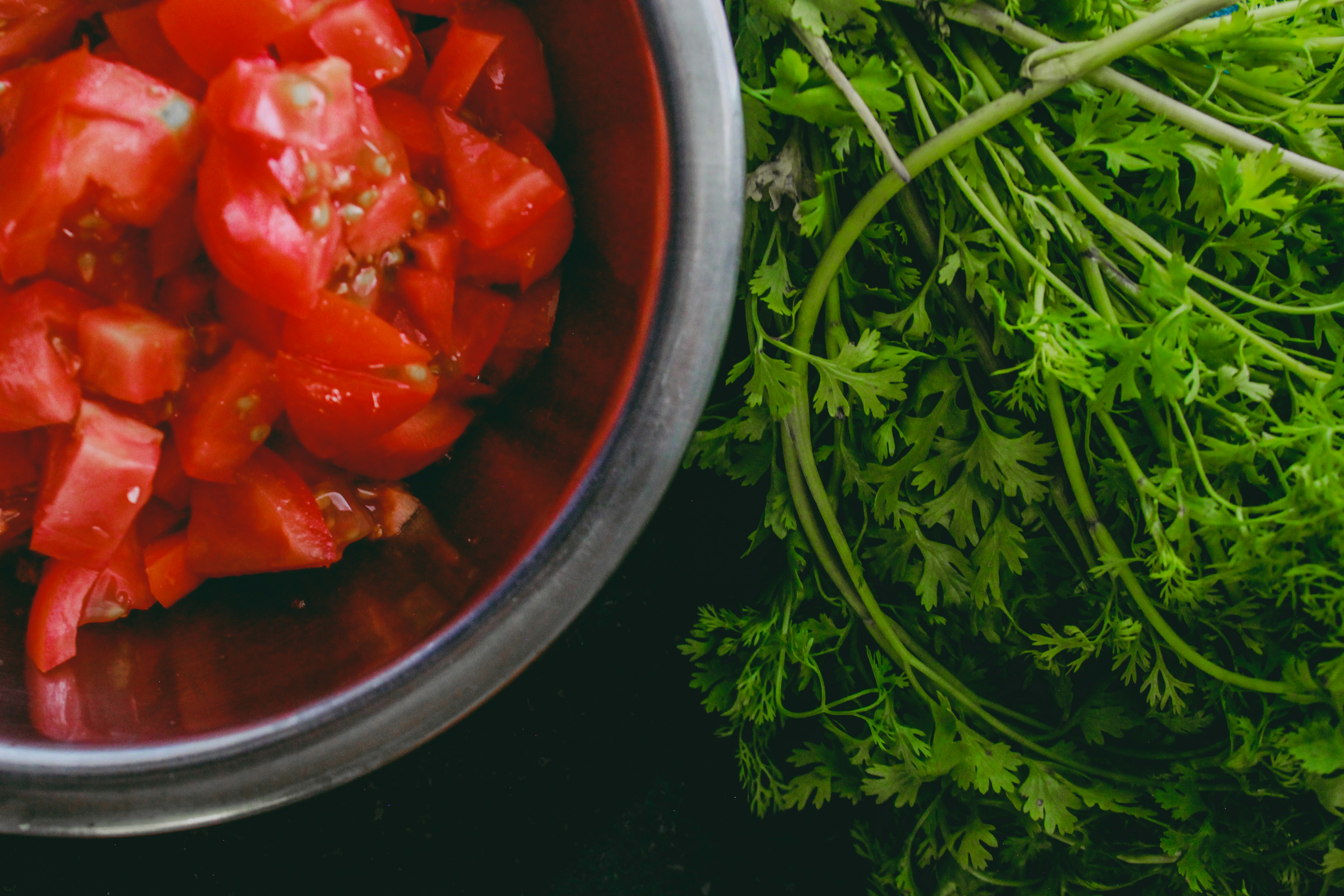 Red sliced tomato in stainless steel bowl photo Free Red Image on