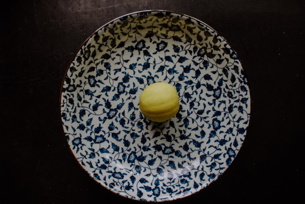 yellow fruit on blue and white round plate