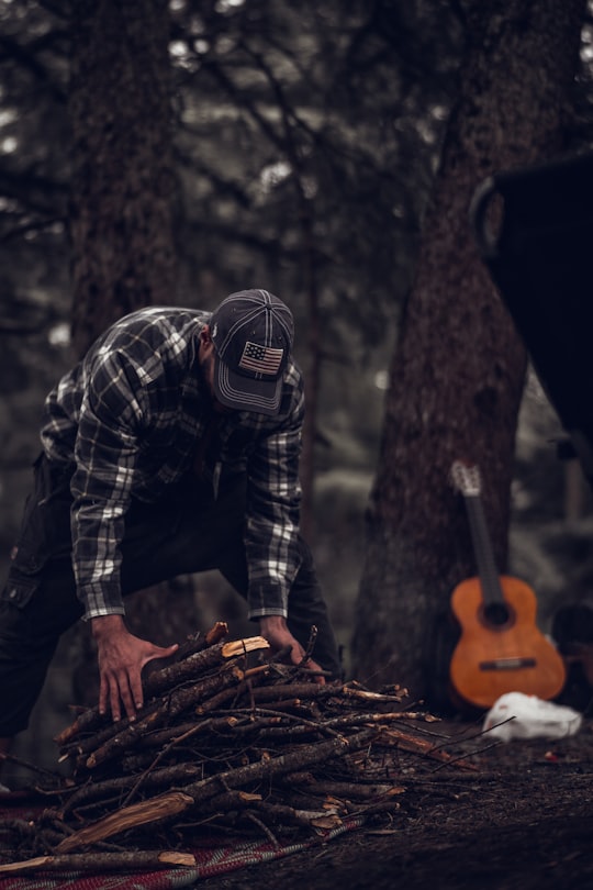 man in black and white plaid long sleeve shirt holding orange jack o lantern in Chrea Algeria