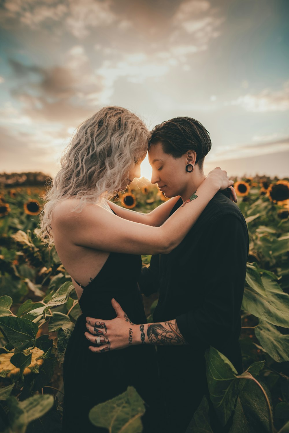 woman in black dress holding yellow flower bouquet