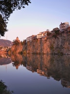 brown concrete building near body of water during daytime