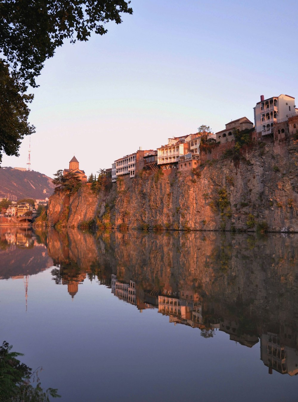 brown concrete building near body of water during daytime