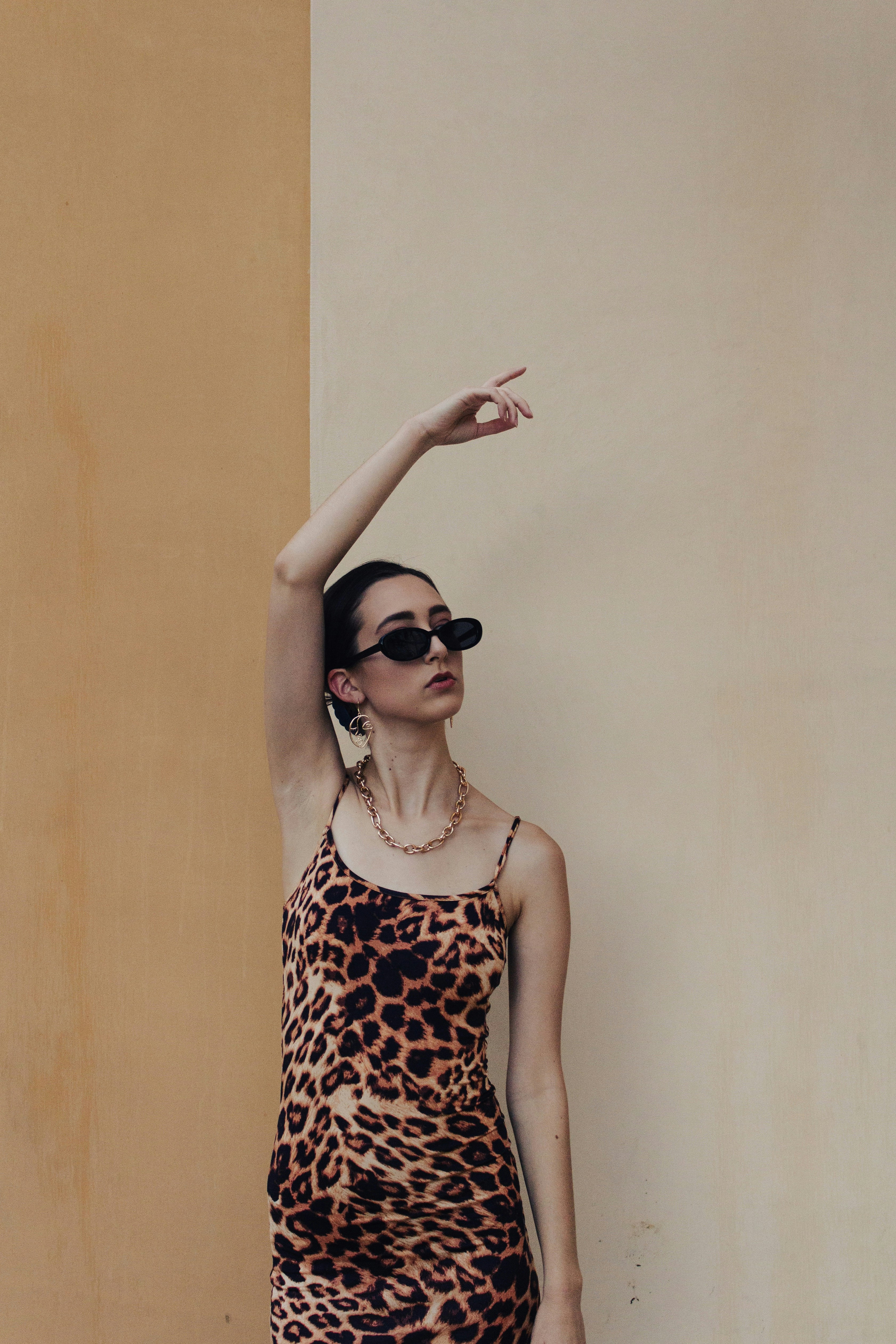woman in black and white polka dot tank top wearing black sunglasses