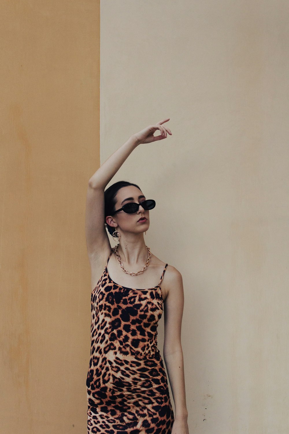 woman in black and white polka dot tank top wearing black sunglasses