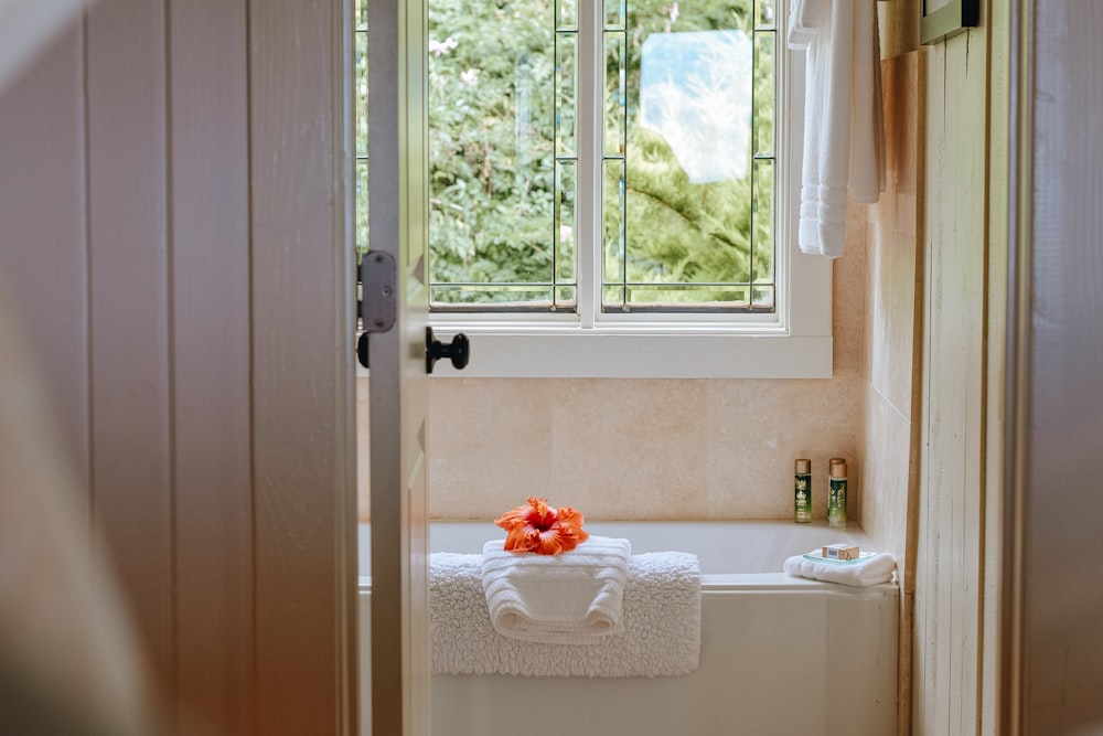 white bath towel on bathtub