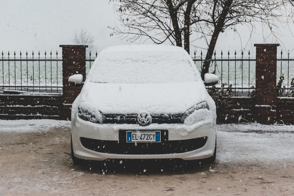 white car parked on snow covered ground