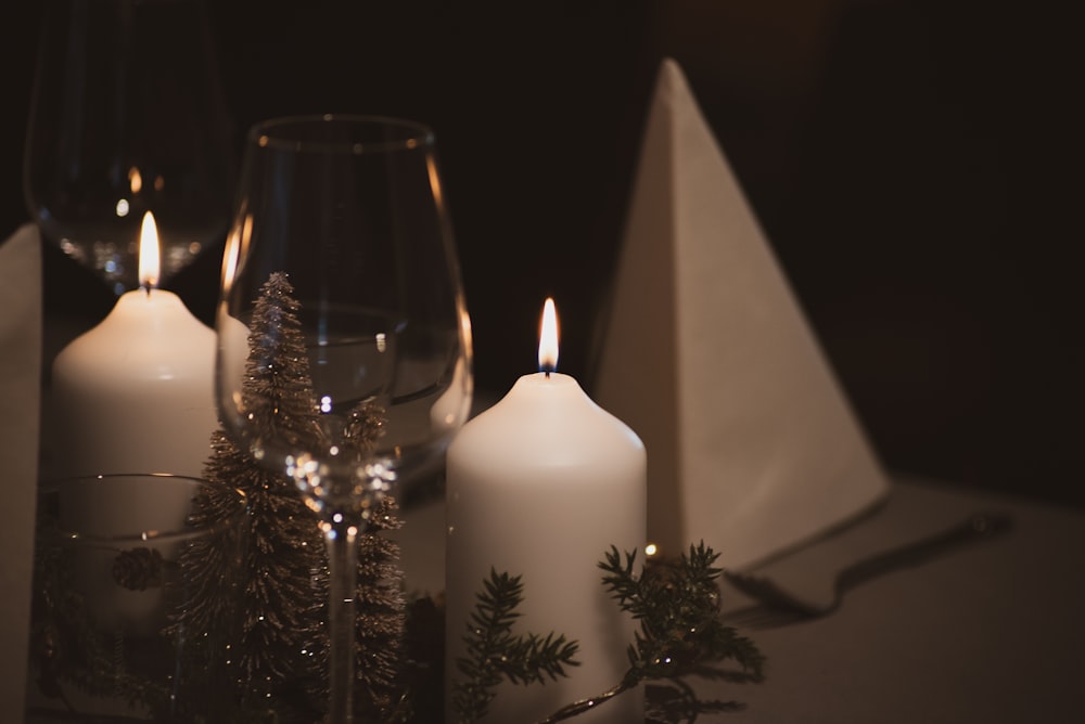 white pillar candle on clear glass candle holder