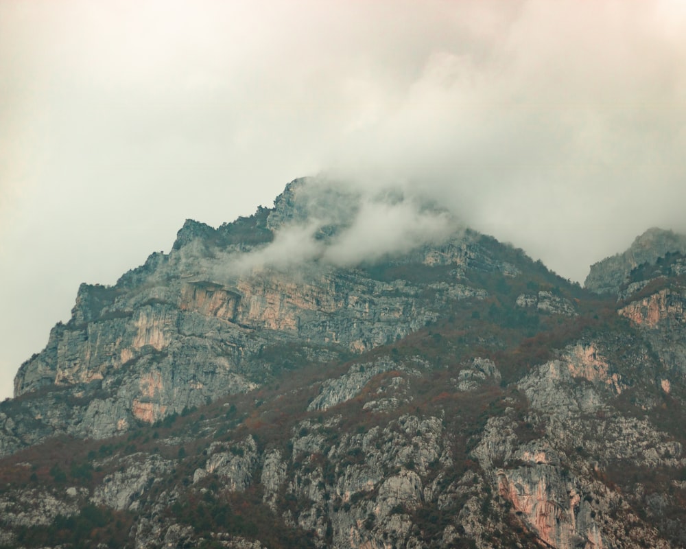 brown and green mountain under white clouds during daytime