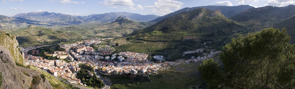 houses on green grass field near mountain during daytime