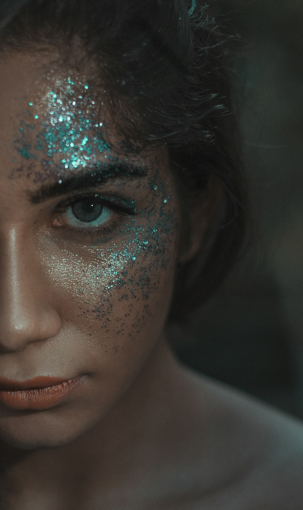 woman with blue and green face paint