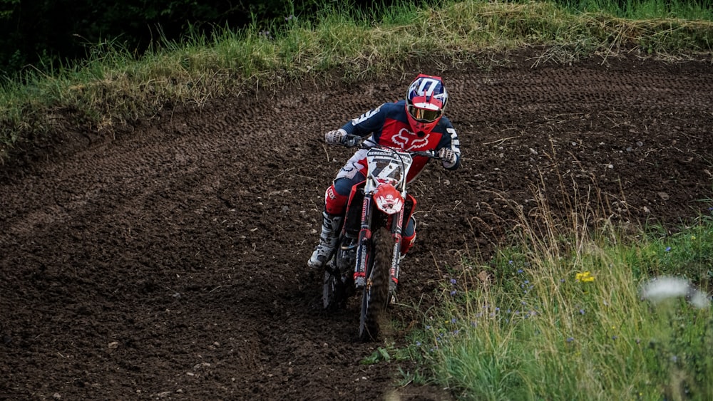 man in red and white motocross suit riding motocross dirt bike