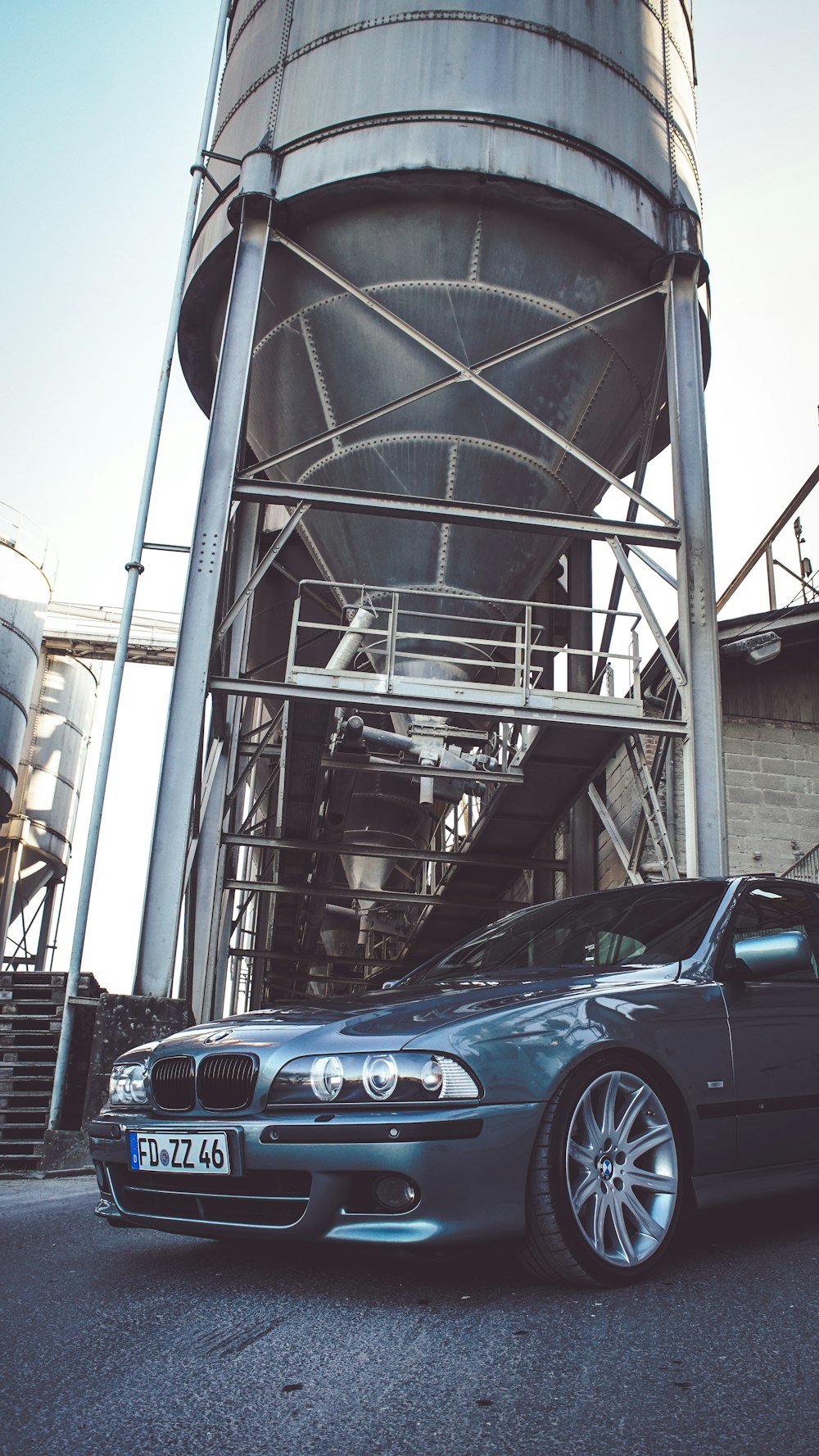 blue bmw m 3 coupe parked on gray concrete building