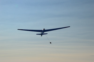 white airplane flying in the sky during daytime
