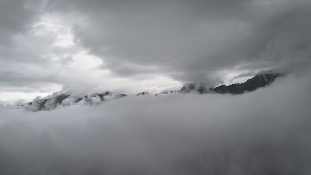 white clouds over mountains during daytime