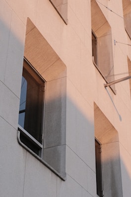 Urban architectural facade featuring elegant natural stone cladding in sunlight.