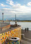 people standing on dock near bridge during daytime