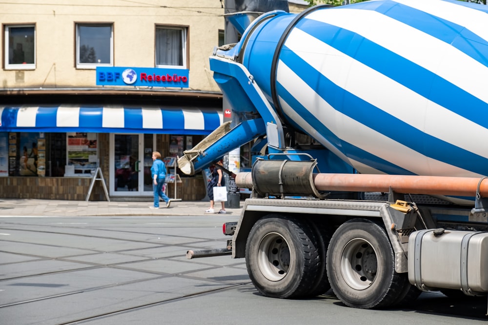 blue and white truck on road during daytime