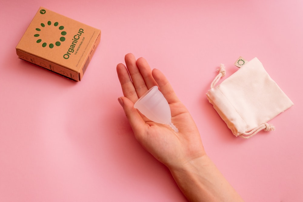 persons hand on pink surface