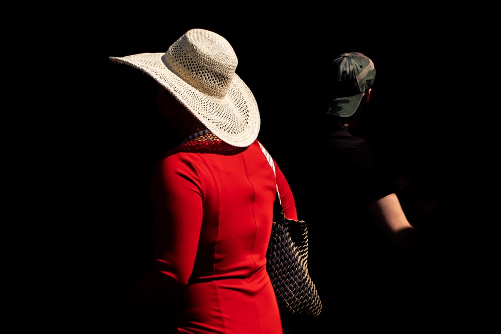 woman in red long sleeve dress wearing white and black hat