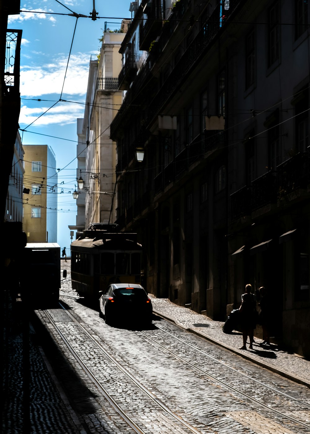 black car parked beside building during daytime