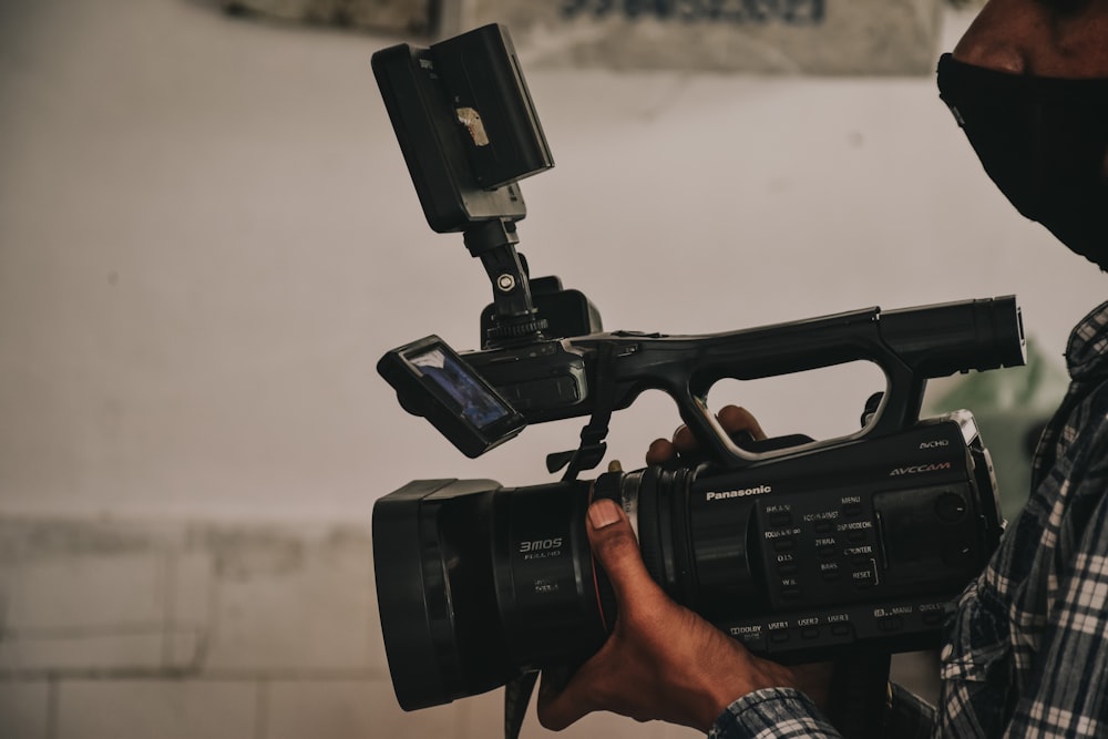 black video camera on persons hand