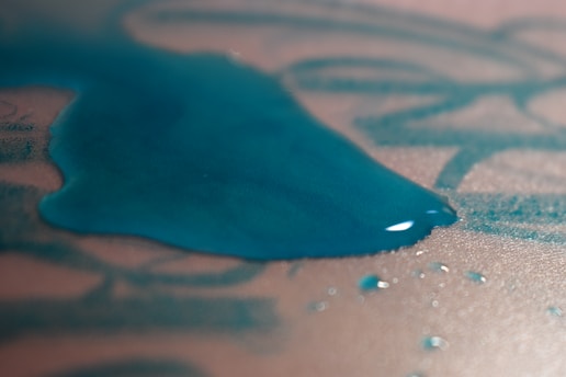 Close-up of a fabric with a stain being removed using a chemical product