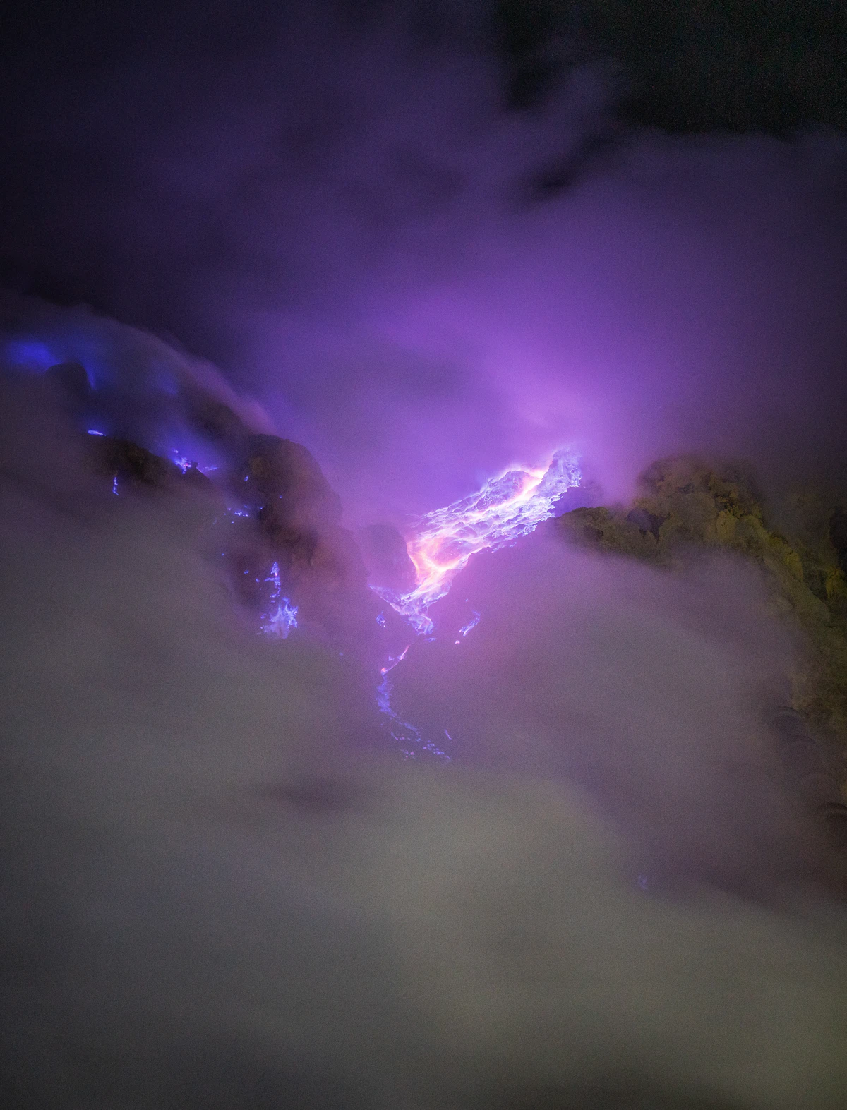 Turquoise crater lake of Kawah Ijen at sunrise, seen from the rim